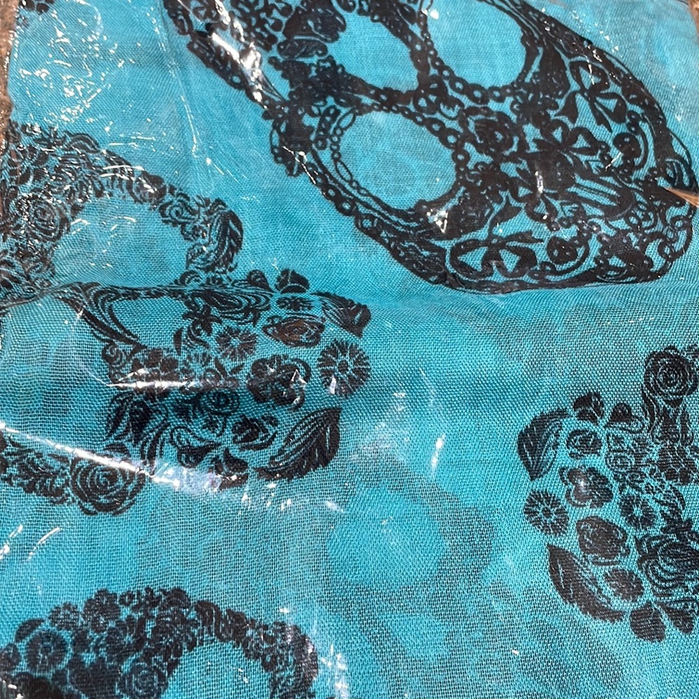 Skeleton scarf turquoise color with navy blue skeletons.